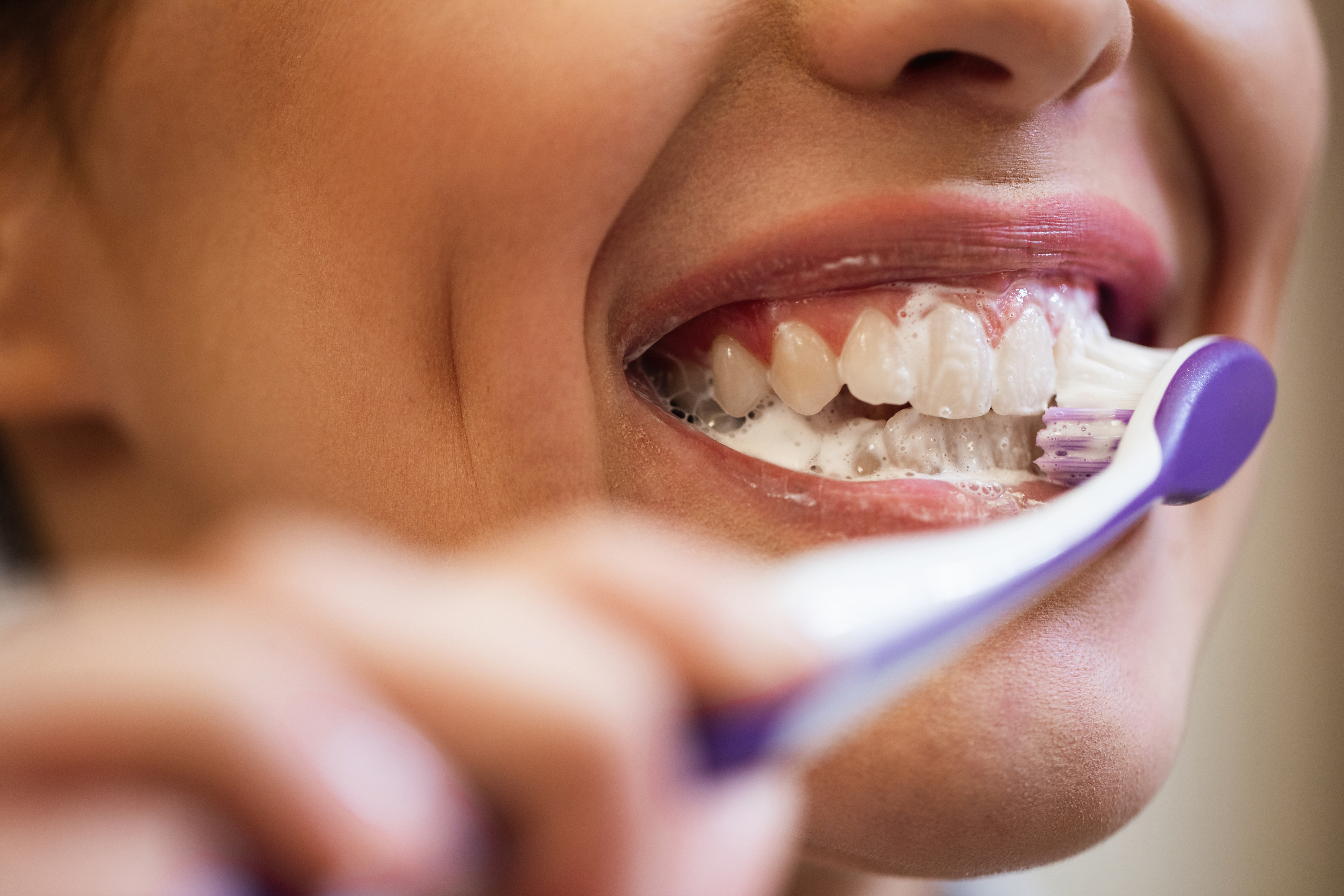 Close-up of healthy gums and teeth during a gum pain assessment